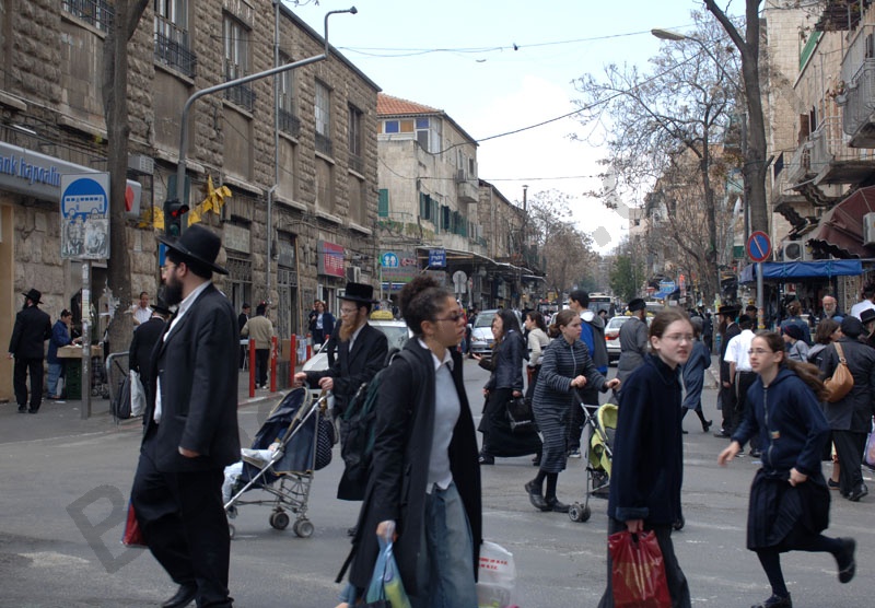 Mea Shearim is a head's street. Jews welt in Israel. Ortodox man, end woman living  in Mea Shearim ultraortodox jews quarter.