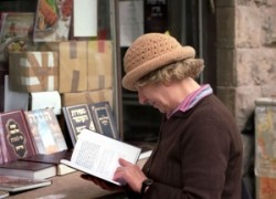   Whoman reading in front of the Book shop.